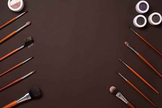 brush for makeup, eye shadow, view from above. On a brown background photo