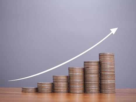 Stack of coins with arrow rising icons. The concept of business growth, Financial investment, Market stock, Profit return, Dividend and Business fund. photo