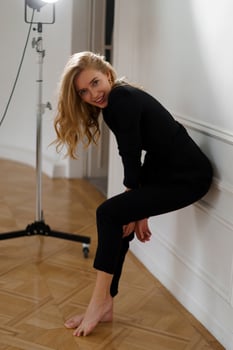 Smiling blond woman in casual outfit posing in studio. Fashion look. photo
