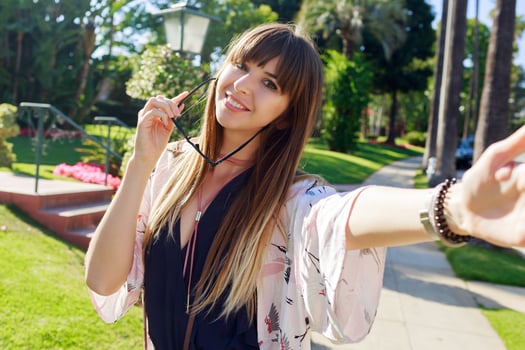 Amazing stylish  woman in blue playsuit  and white kimono enjoying vacation. She is smiling, showing signs. photo