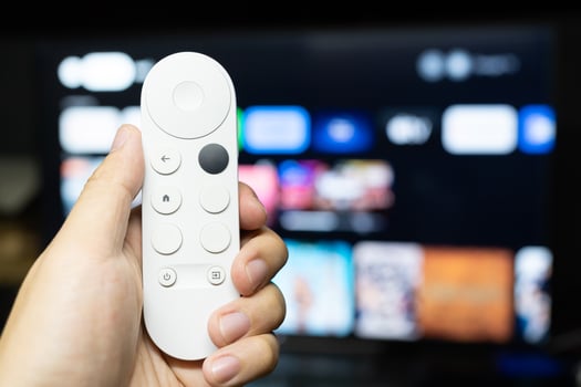 Hand holding modern remote for control watching tv. photo