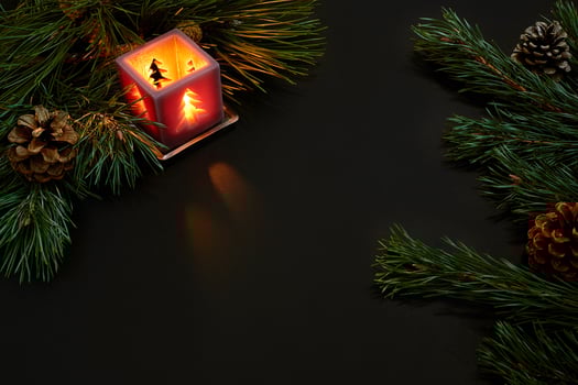 Christmas, christmas tree, candle, cones and cinnamon sticks on black background photo