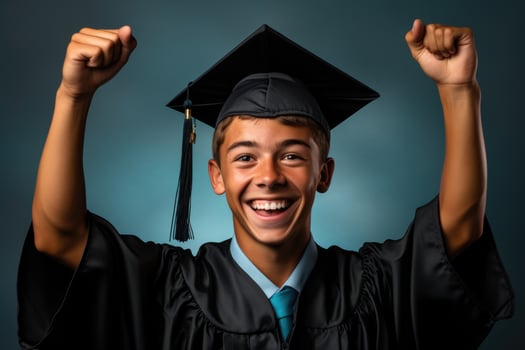 A triumphant youth holding a graduation cap isolated on a gradient background photo
