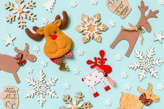 Top view of holiday decorations and toys on blue background. Christmas ornament concept photo
