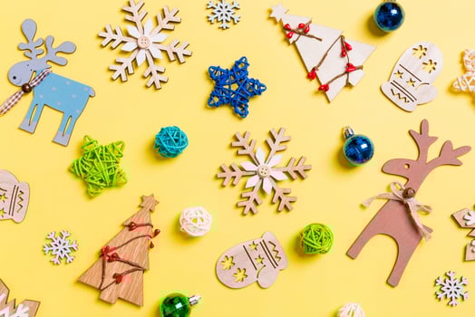 Top view of yellow background with New Year toys and decorations. Christmas time concept photo