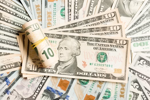 Close up of 10 dollar bills pile on background made with different dollar banknotes. Top view of financial concept photo