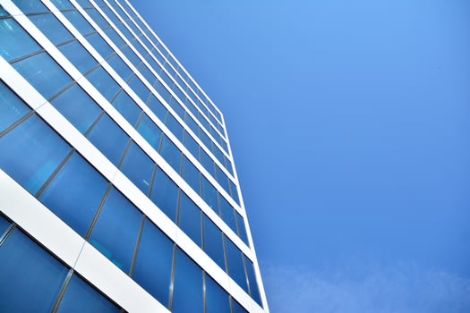Modern office building in the city with windows and  steel and aluminum panels wall. Contemporary commercial architecture, vertical converging geometric lines. photo