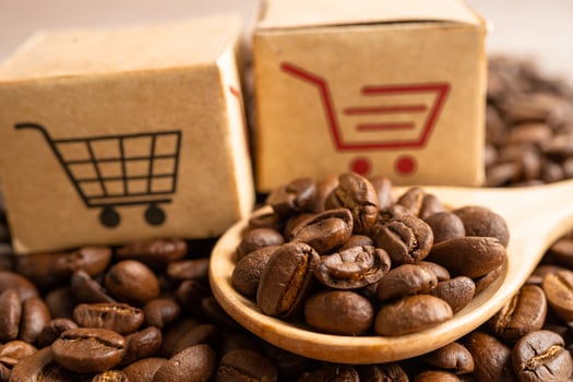 Box with shopping cart logo symbol on coffee beans, Import Export Shopping online or eCommerce delivery service store product shipping, trade, supplier concept. photo
