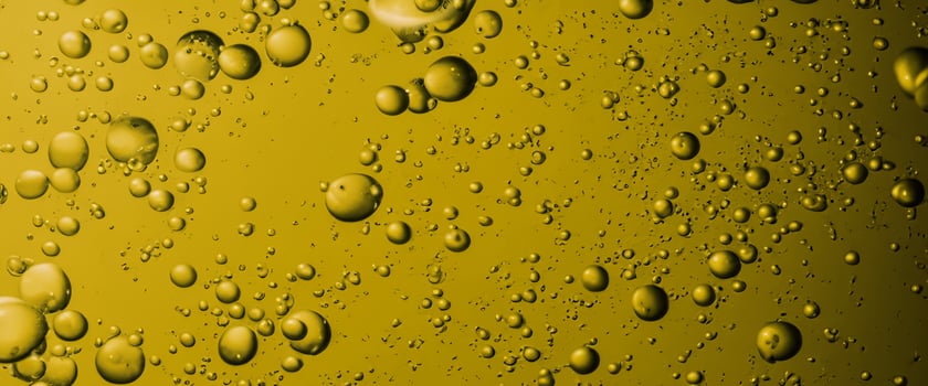 Golden Hyaluron Oil bubbles collagen serum or yellow oil bubbles drop texture background photo