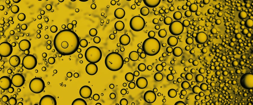 Golden Hyaluron Oil bubbles collagen serum or yellow oil bubbles drop texture background photo