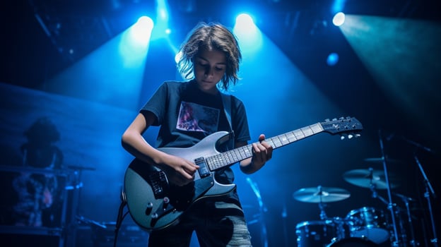 young musician performs rock music on stage photo