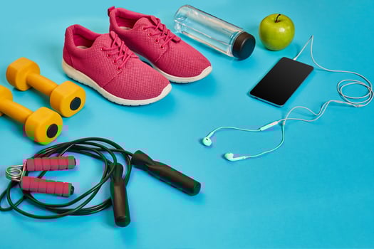 Flat lay of dumbbell, bottle of water, jump rope and sneaker, sport equipments, fitness items, top view photo