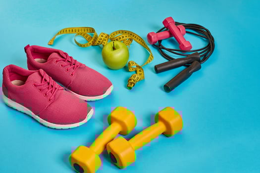 Flat lay of dumbbell, bottle of water, jump rope and sneaker, sport equipments, fitness items, top view photo