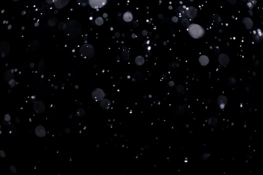 small drops of rain, snow on a black background. wind. Natural background photo