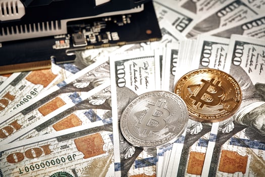 The coins of bitcoin lies on dollars with video card. Exchange bitcoin cash for a dollar photo