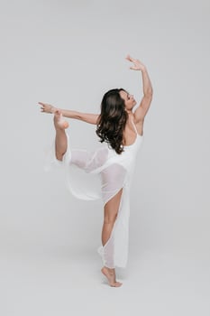 Fit adult recovering from workout practice with stretching exercise in studio. Concept of healthy life and natural balance between body and mental development. photo