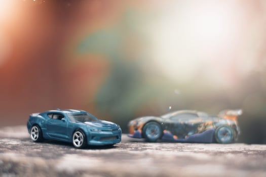 photo of a blue toy car with a blurred background