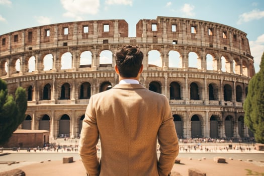 Rear view of young man looking at Colosseum in Rome, Italy, Male tourist standing in front of a sandy beach and watching the sea, rear view, full body, AI Generated photo