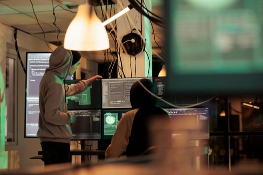 Diverse men working together to break security server, planning data breach with malware and trojan virus. Male hackers doing cyberterrorism attack and stealing passwords, phishing. photo