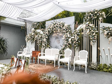 wedding stage for an elegant wedding event filled with flowers in a garden with a natural and outdoor feel photo