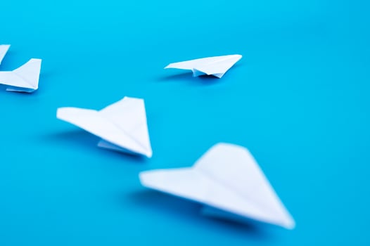 Low view of white paper plane origami leading white paper planes. With copy space for text. photo