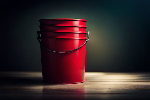 a red bucket sitting on a wooden table. AI-Generated photo