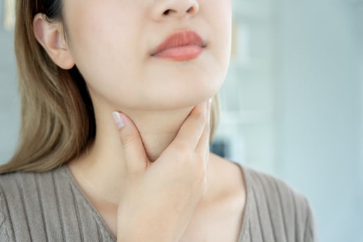 Asian woman put her hand on her neck due to a sore throat. female tonsillitis causes a inflammation. treated by taking water, taking antibiotics, consult a doctor, virus, corona virus, Influenza, flu photo