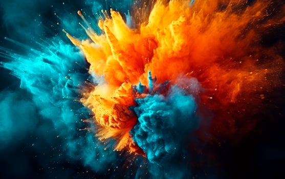 Blue and orange colored powder explosions over black background. Holi paint powder splash. photo