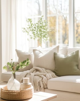 A minimalist photography of a white couch, accentuated by soft pillows and complemented by a simple coffee table.. Generative AI photo