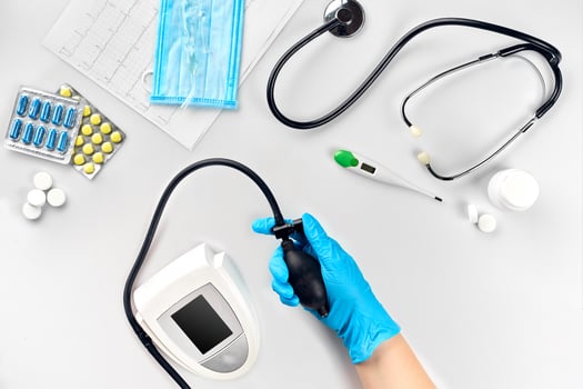 Close-up of tonometer by patients arm during blood pressure measuring at medical consultation photo