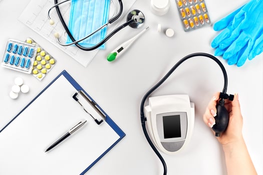 Close-up of tonometer by patients arm during blood pressure measuring at medical consultation photo