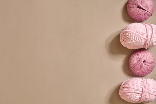 Pink knitting yarn balls top view photo