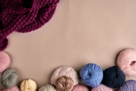 Set of colorful wool yarn on beige background. Top view photo