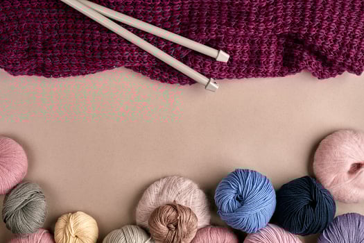 Set of colorful wool yarn on beige background. Top view photo