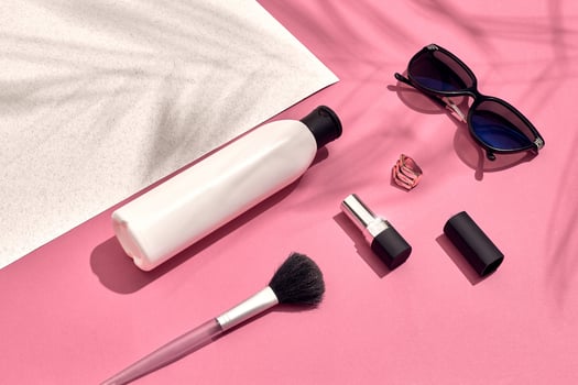 Woman's accessories lying flat on textured paper background. Pink and white pastel colors with copy space around products. photo
