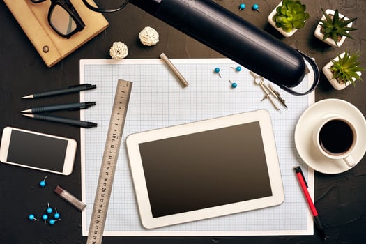 Engineer's desk in office with various gadgets and documents photo