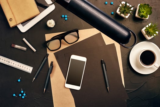 Engineer's desk in office with various gadgets and documents photo