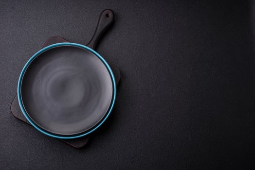 Beautiful empty round ceramic plate on a concrete background photo