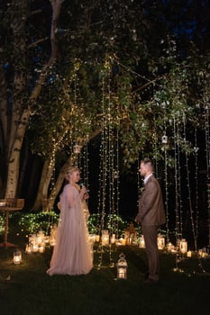 night wedding ceremony of the newlyweds in a country cottage photo