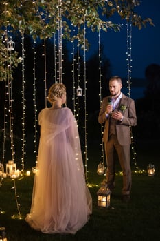 night wedding ceremony of the newlyweds in a country cottage photo