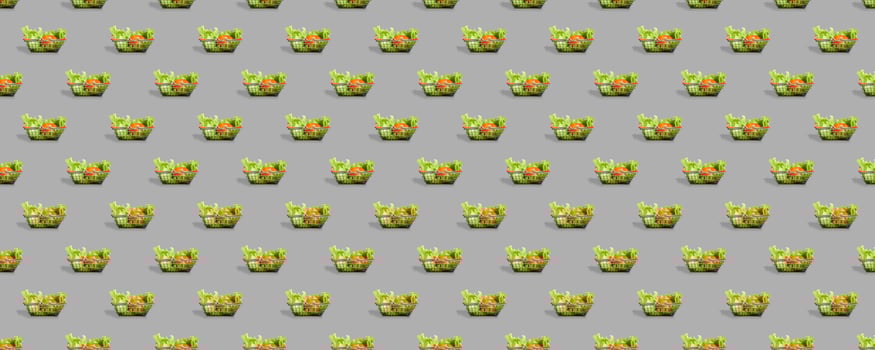 Fresh vegetables in a metal shopping cart. Seamless pattern of shopping baskets isolated on gray background. photo