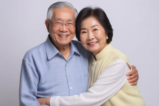 Happy Asian senior couple in light background. Concept of success in business and life. photo