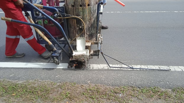 Worker painting white line photo