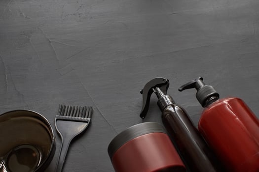 Top view of a professional hairdresser kit with copy space on a black background. photo