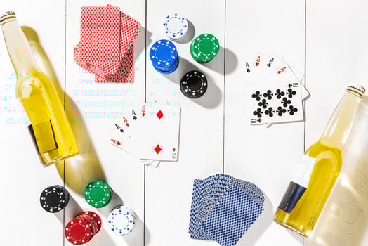 Poker. Set to playing poker with cards and chips on white wooden table, top view photo