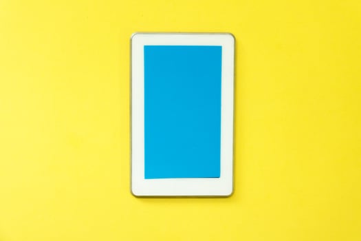 a white tablet computer on a yellow background photo