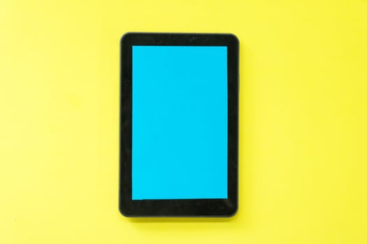 a black smartphone on a yellow background photo