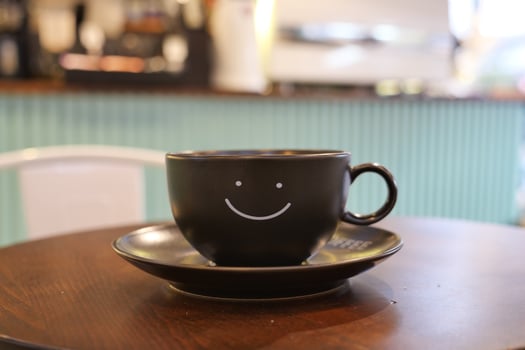 black coffee cup with smile shape design on it photo