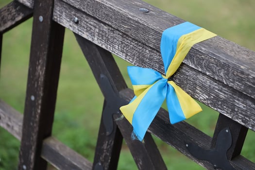 Ribbons in the colors of the national flag of Ukraine are tied to the handrail photo