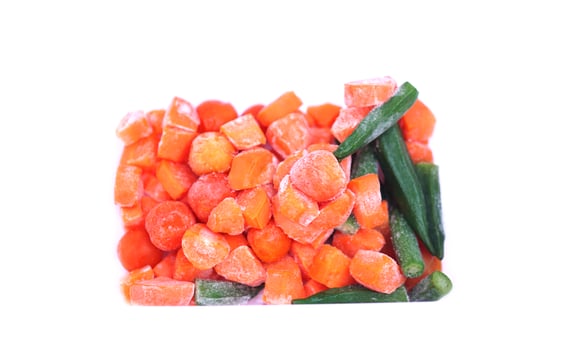 Frozen pieces of carrot, tomatoes and green okras , isolated on white background. Concept, food preservation by freezing process for long lasting of food. Keep fresh and nutrients. photo